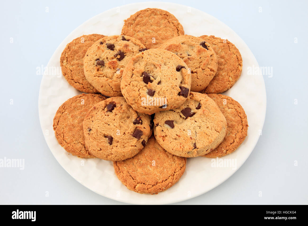 Top down of a plate of round oat and chocolate chip biscuits. Stock Photo