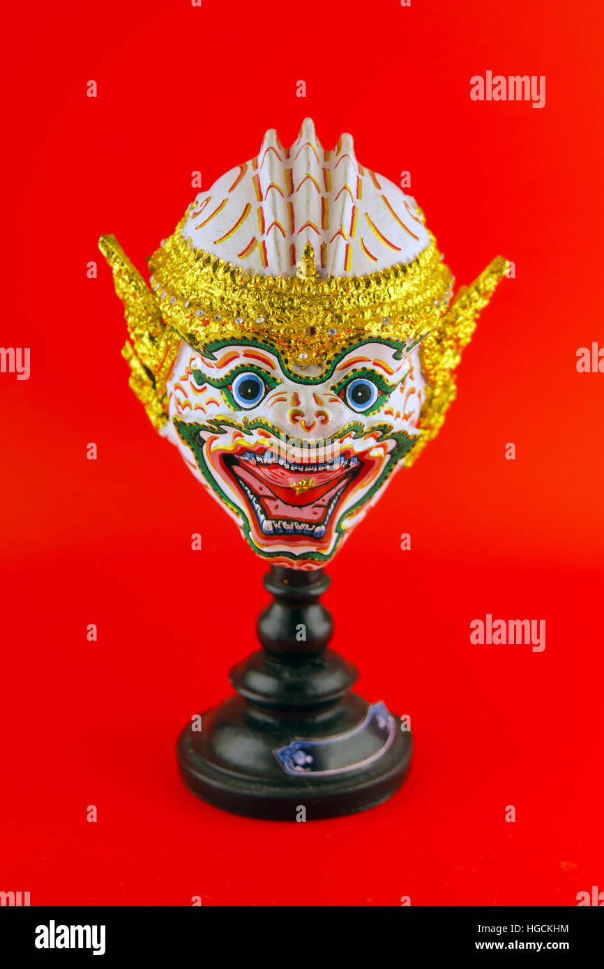 Hua Khon (Ancient Thai Show Head Mask) use in Khon Thai classical style of Ramayana Story isolated on red background Stock Photo