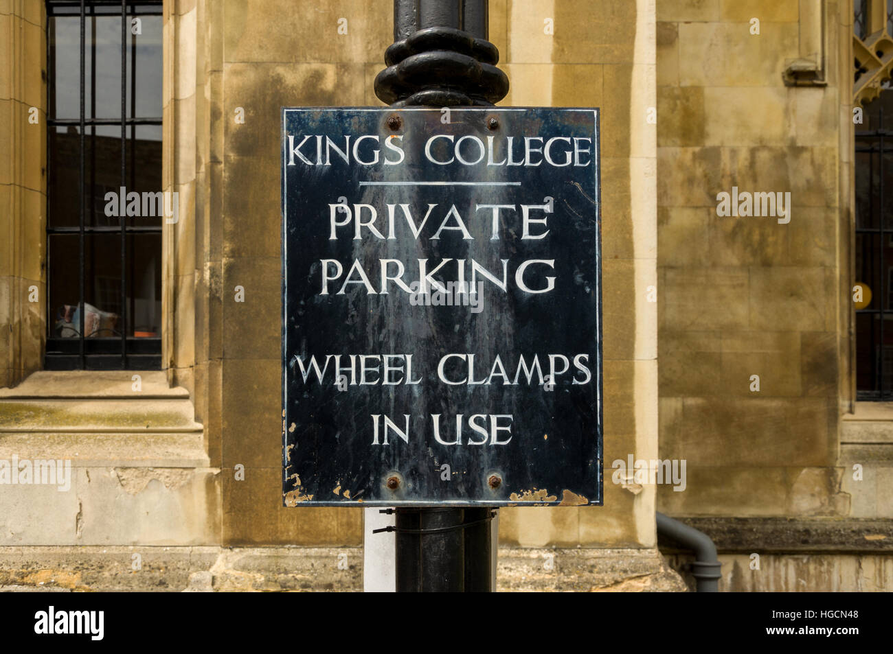 Kings College Cambridge private parking wheel clamps in use sign Stock
