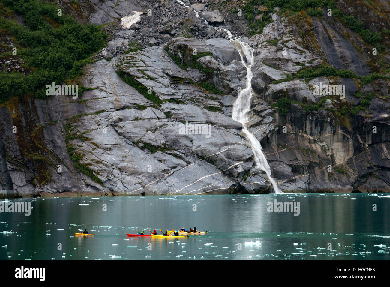 Passengers of cruise ship Safari Endeavour sea kayaking at Fords Terror, Endicott Arm, Tongass National Forest, Alaska, USA. Cliff-walled fjords slice Stock Photo