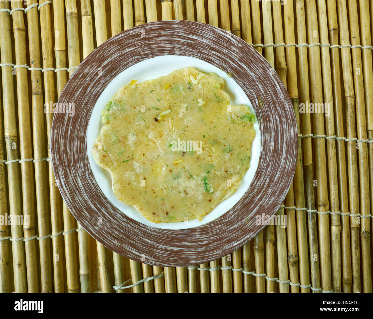 Akki rotti -  Spicy Indian  traditional breakfast dish,made from rice flour, carrot and coconut. Stock Photo