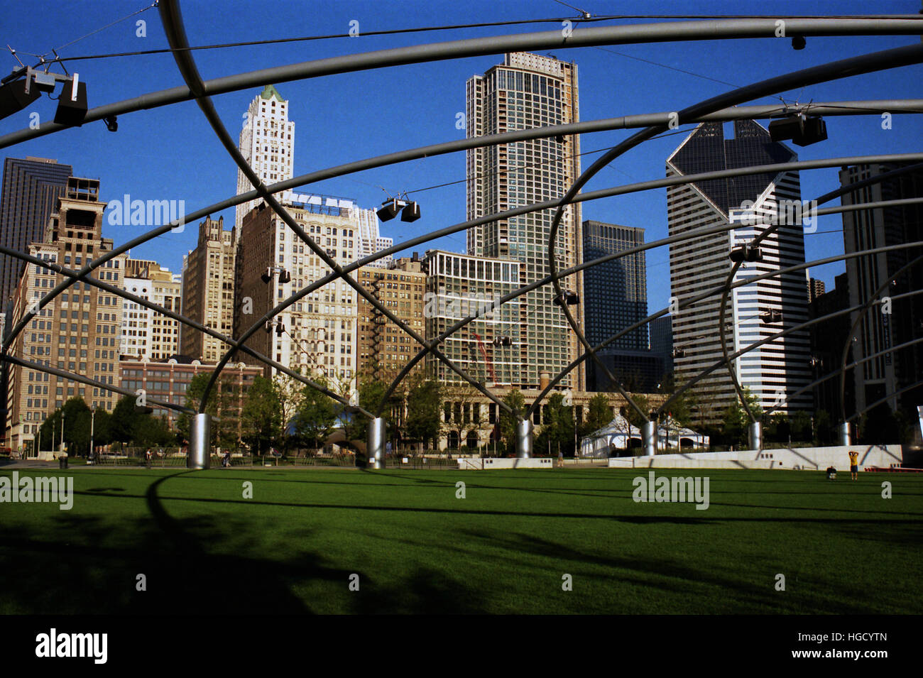 The stainless steel trellis hovers over the lawn at the Jay Pritzker Pavilion in Chicago's Millennium Park. Stock Photo