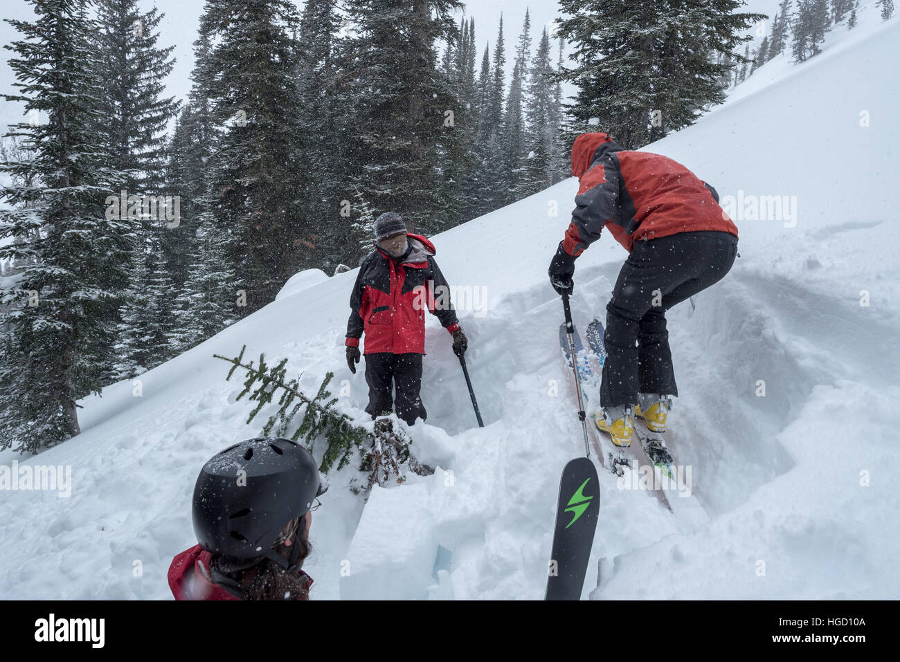 Backcountry skiers assessing an avalanche test pit in Oregon