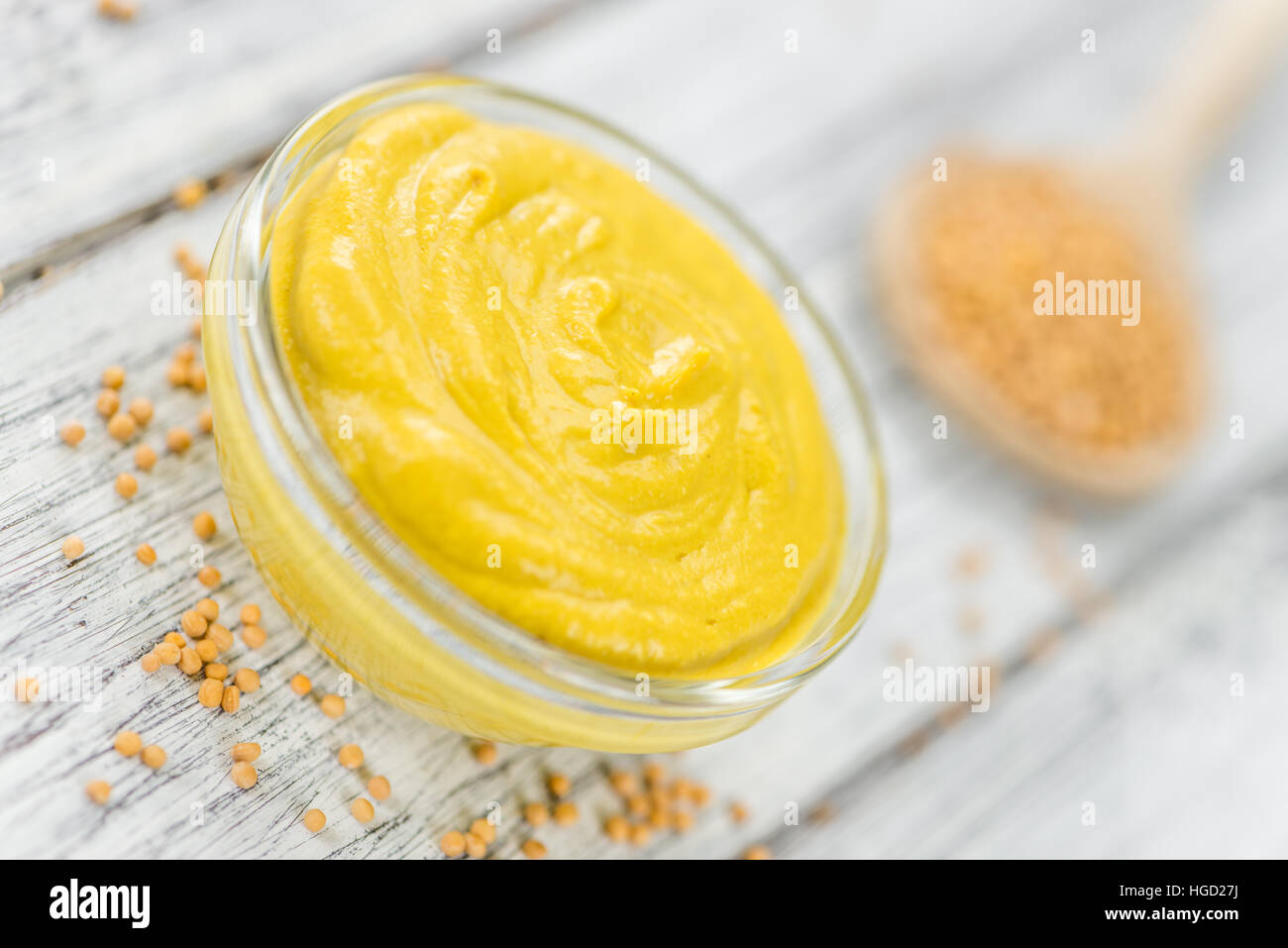 Portion of homemade Mustard on wooden background (selective focus; close-up shot) Stock Photo