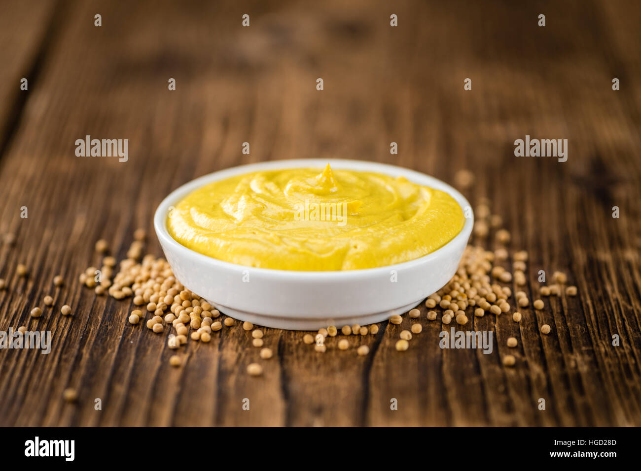 Portion of homemade Mustard on wooden background (selective focus; close-up shot) Stock Photo