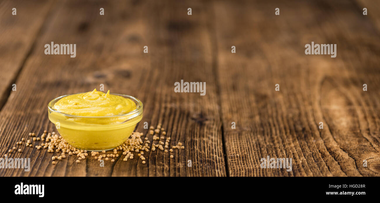 Portion of homemade Mustard on wooden background (selective focus; close-up shot) Stock Photo