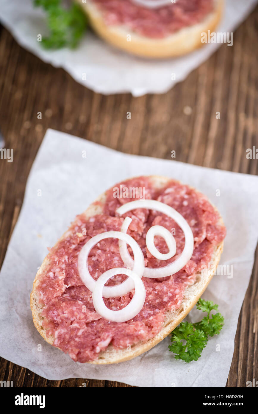 Bun with Mett (German cuisine; selective focus) on wooden background Stock Photo