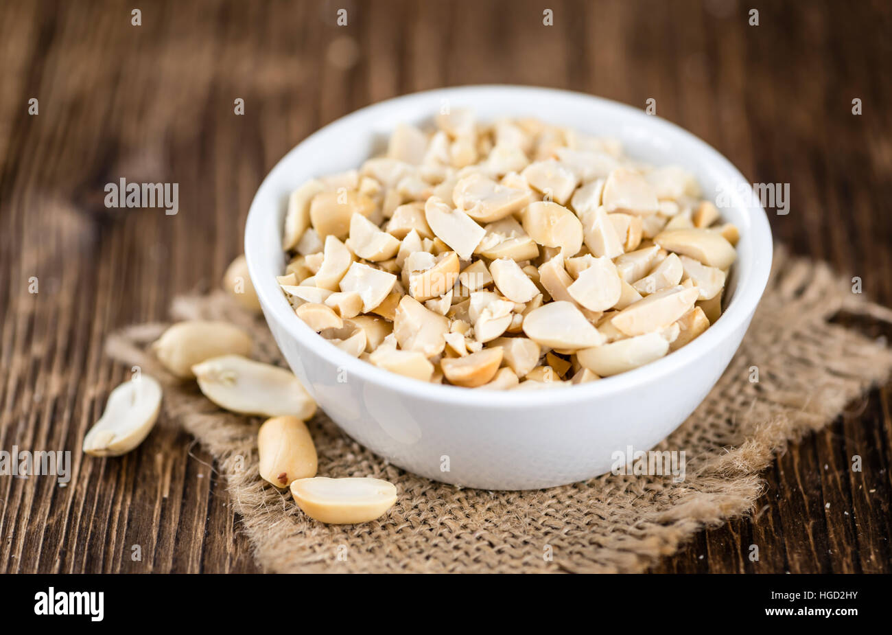 Heap of chopped Peanuts (selective focus) on vintage wooden background Stock Photo