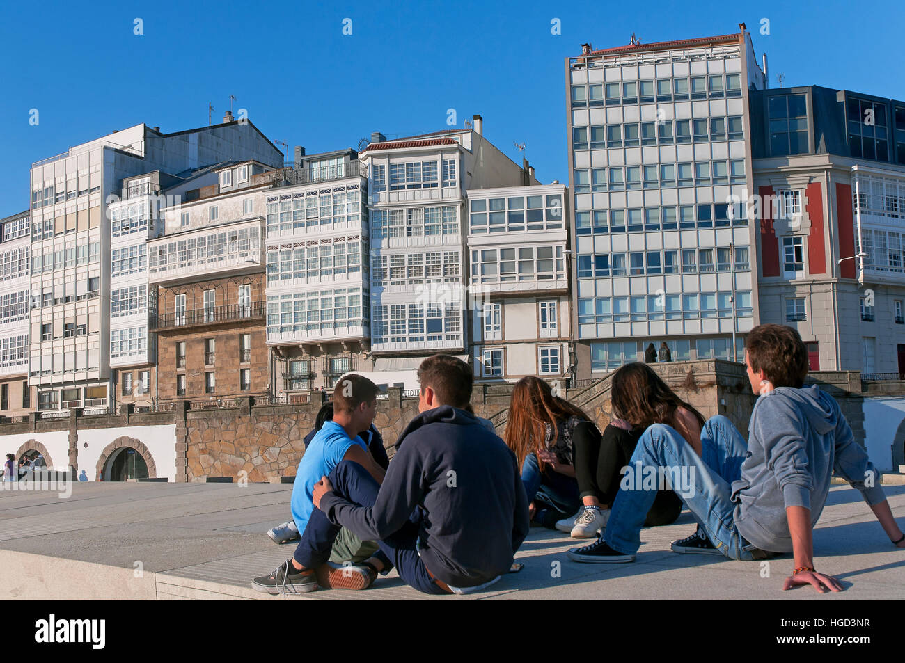 Group of young people next to the port, La Coruña, Region of Galicia, Spain, Europe Stock Photo