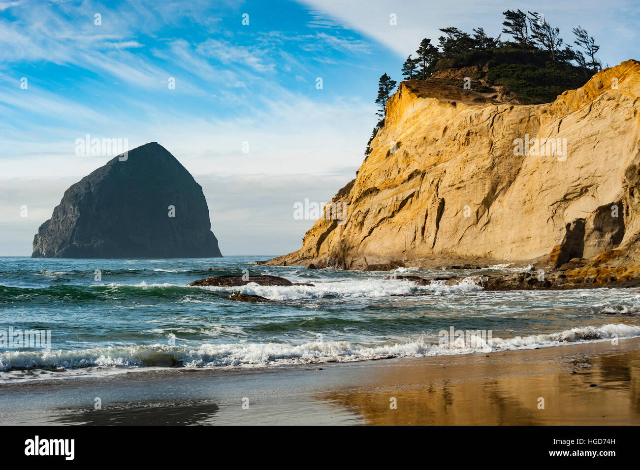Atmospheric landscape, ocean waves wash the Cape Kiwanda beach on the Oregon coast area of Pacific City. Stock Photo