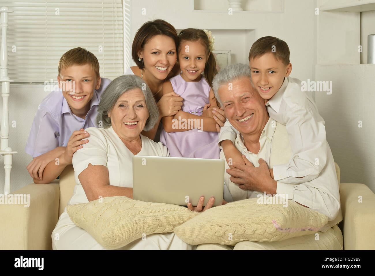 big family posing in home interior Stock Photo - Alamy