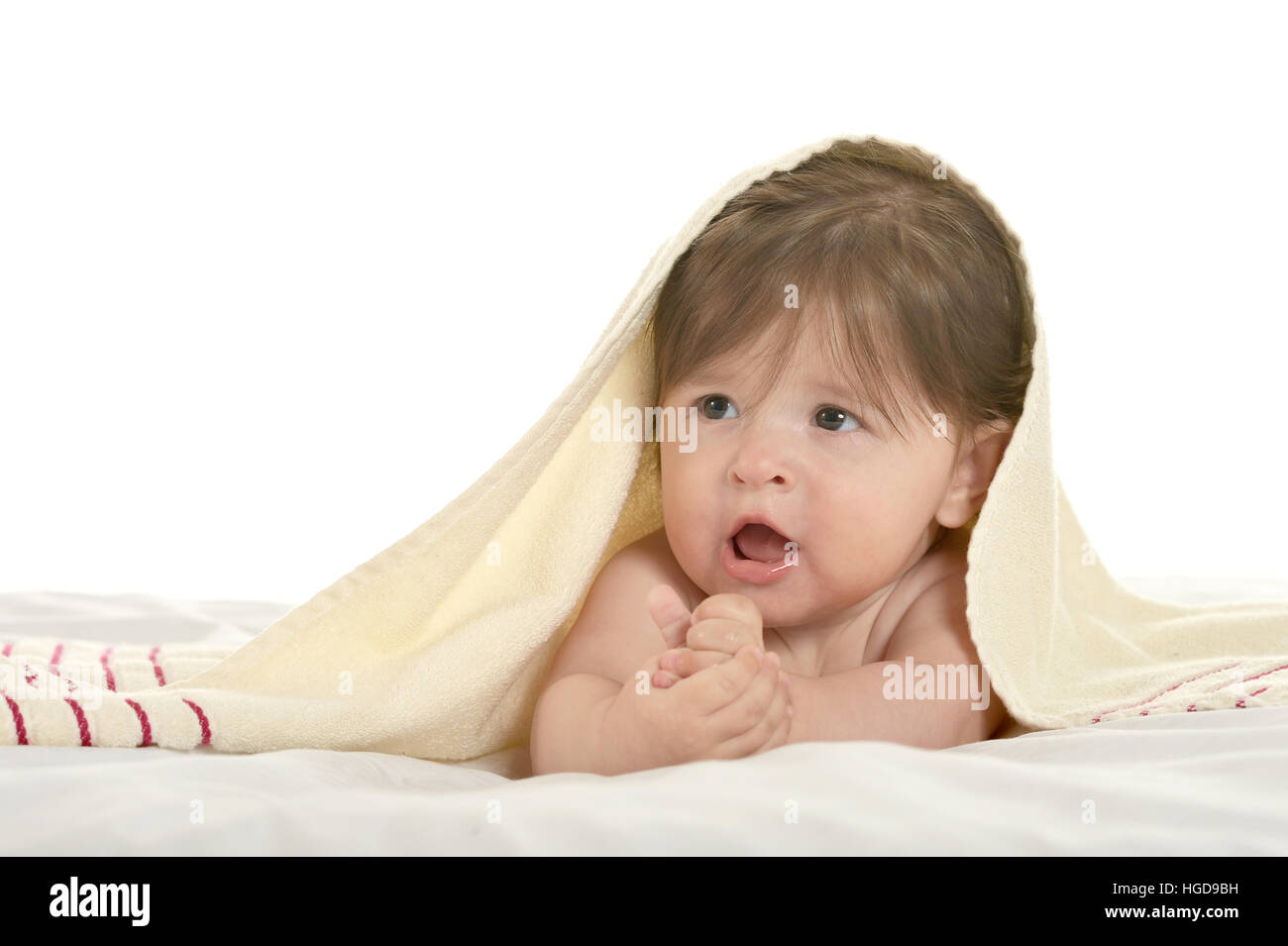 Baby girl lying under blanket Stock Photo Alamy