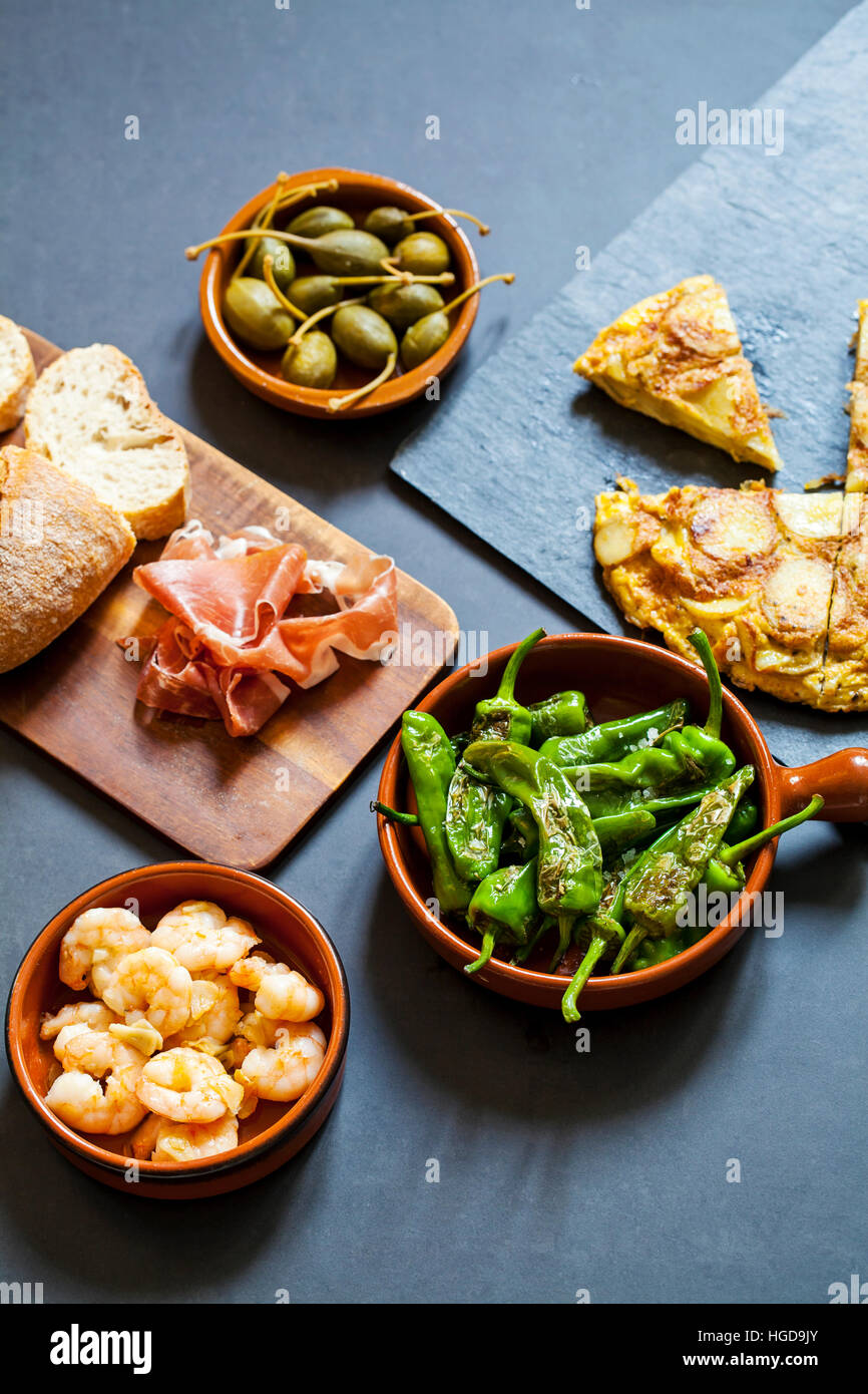 Authentic Spanish tapas with padron peppers,  garlic prawns and traditional tortilla Stock Photo