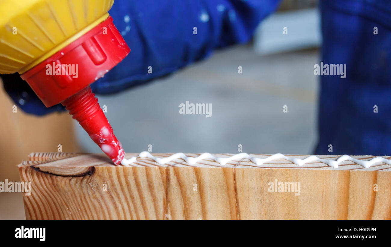 Carpenter at work using glue in his Stock Photo Alamy