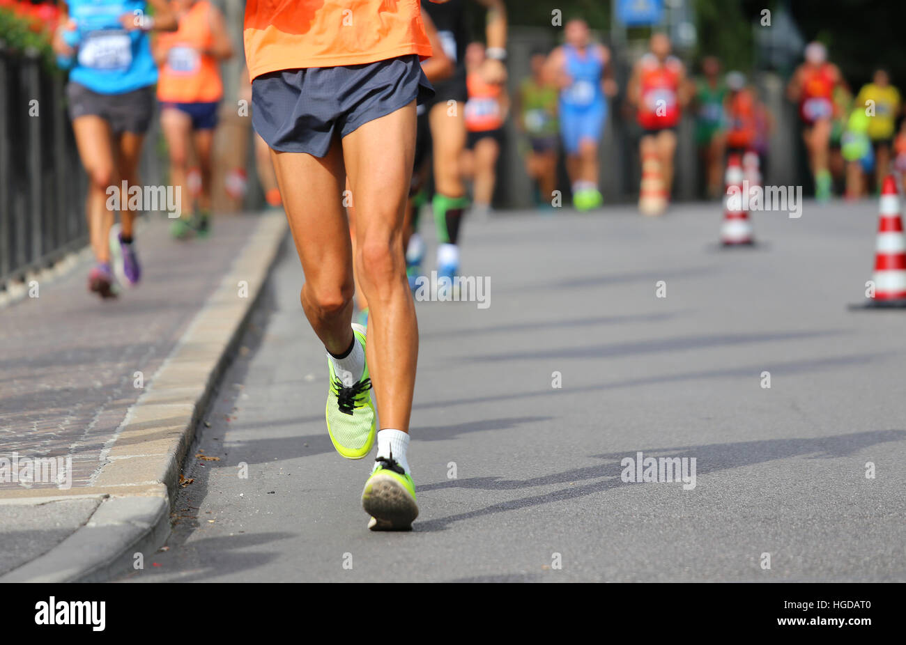 runner during race walking in the city with many athletes from all ...