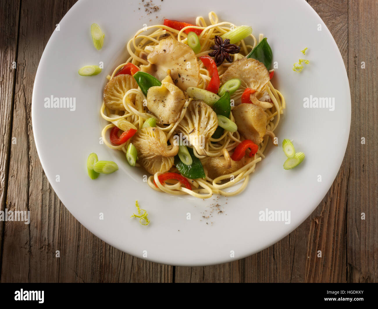 Yellow Oyster mushroom stir fry with noodles, mange tout, red pepper, spring onions and anise Stock Photo