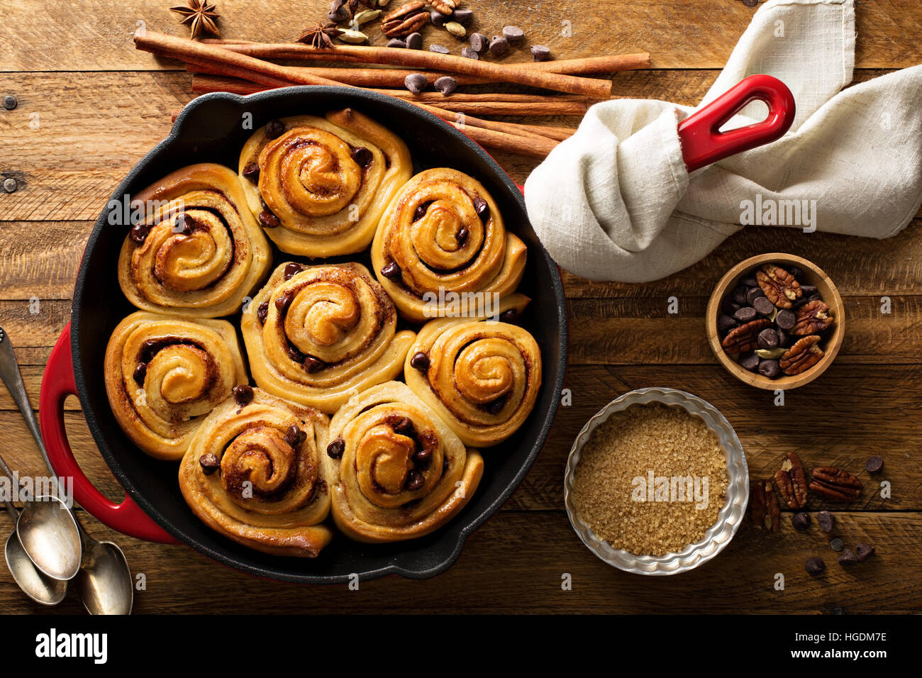 Cinnamon buns with chocolate chips baked in a cast iron pan overhead shot Stock Photo