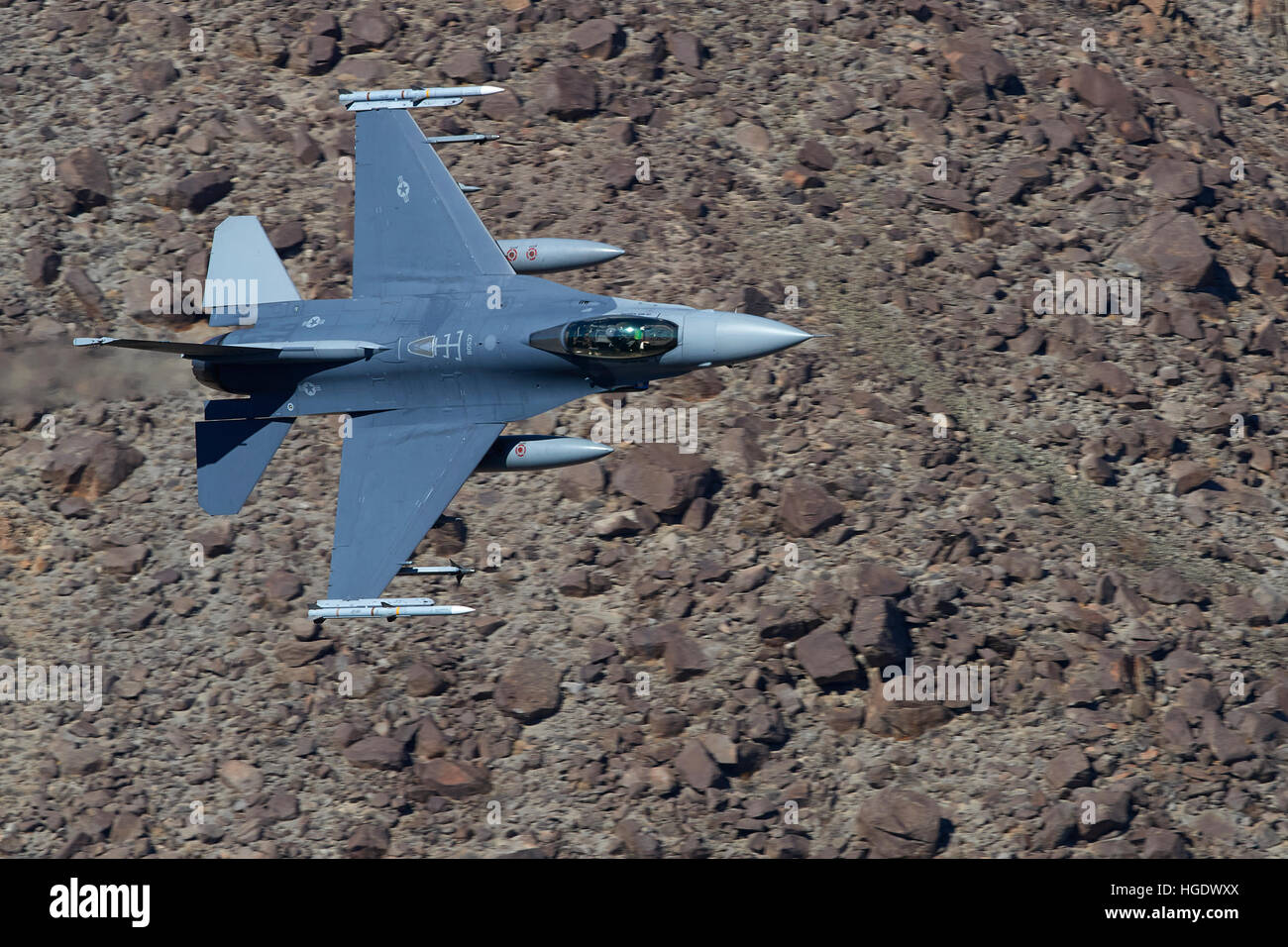 US Air Force F-16C, Flying Through Rainbow Canyon, California. Stock Photo