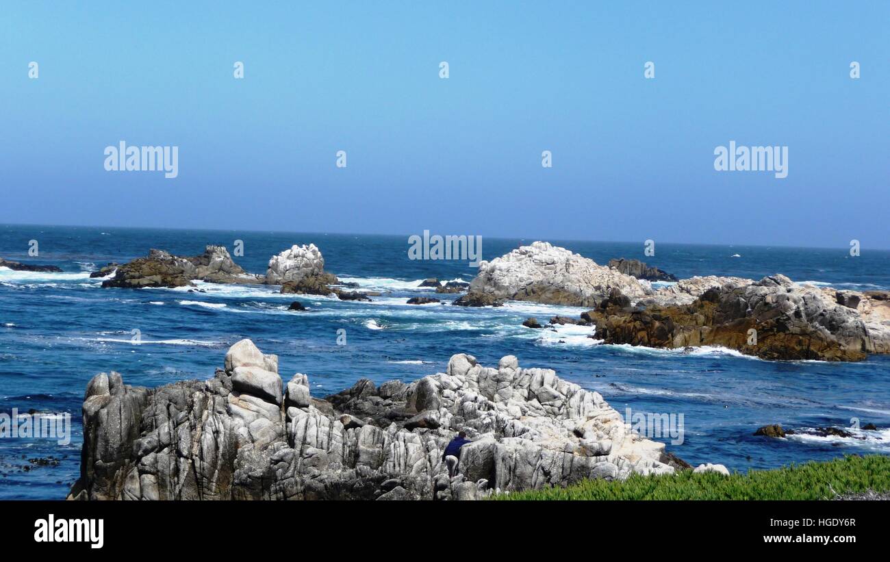 Rocky coast with sunshine and breaking waves Stock Photo - Alamy