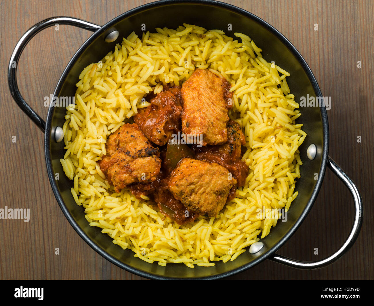 Freshly Cooked Authentic Indian Style Spicy Chicken Jalfrezi Curry Served With Yellow Pilau Rice Meal With No People And Flat Lay Composition Stock Photo