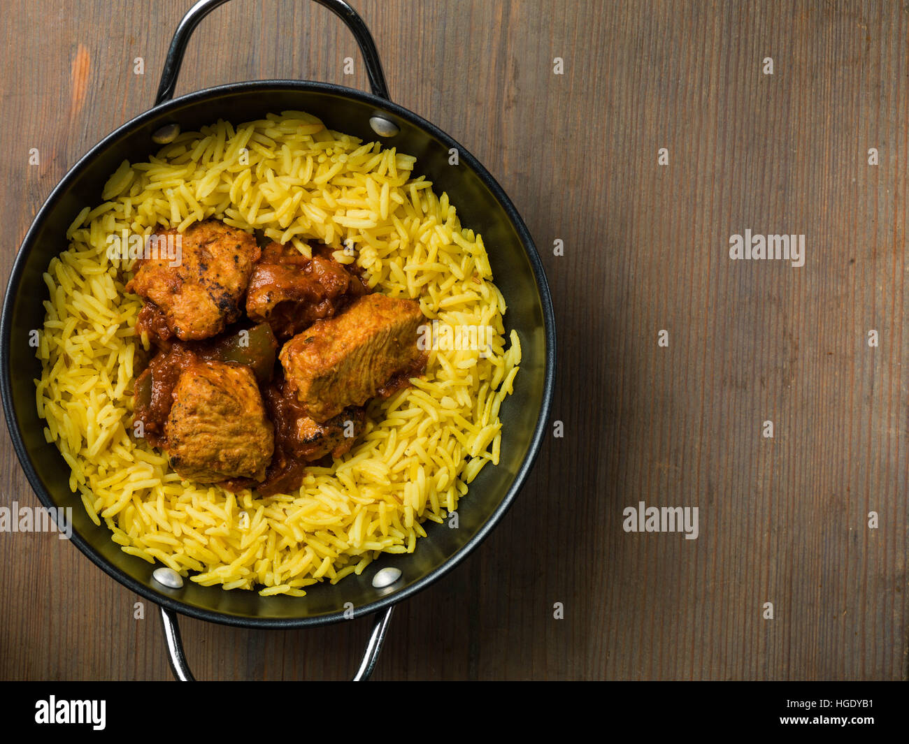 Freshly Cooked Authentic Indian Style Spicy Chicken Jalfrezi Curry Served With Yellow Pilau Rice Meal With No People And Flat Lay Composition Stock Photo