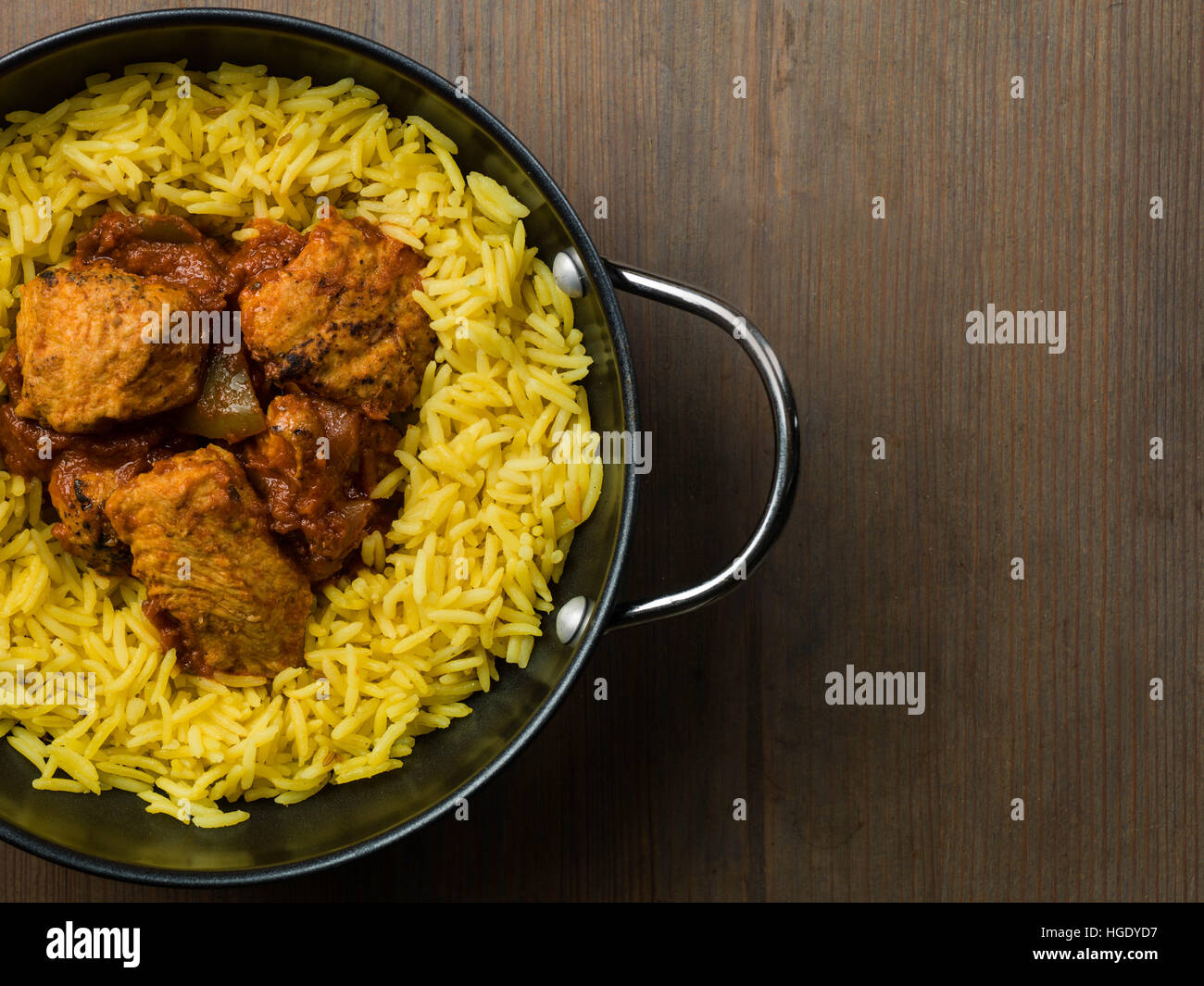 Freshly Cooked Authentic Indian Style Spicy Chicken Jalfrezi Curry Served With Yellow Pilau Rice Meal With No People And Flat Lay Composition Stock Photo
