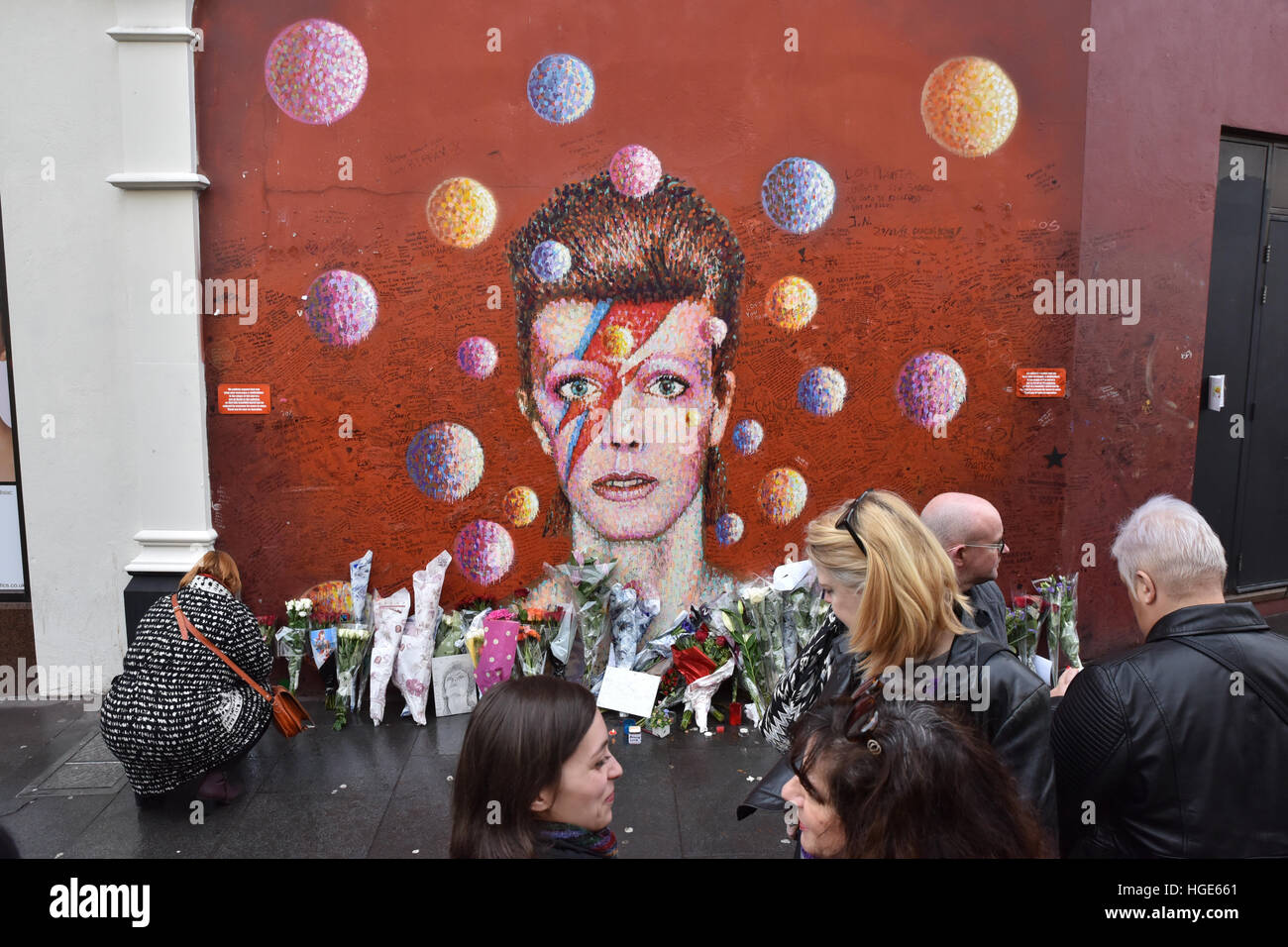 Brixton, London, UK. 8th January 2017. People at the mural in Brixton, respects David Bowie 70th birthday Stock Photo