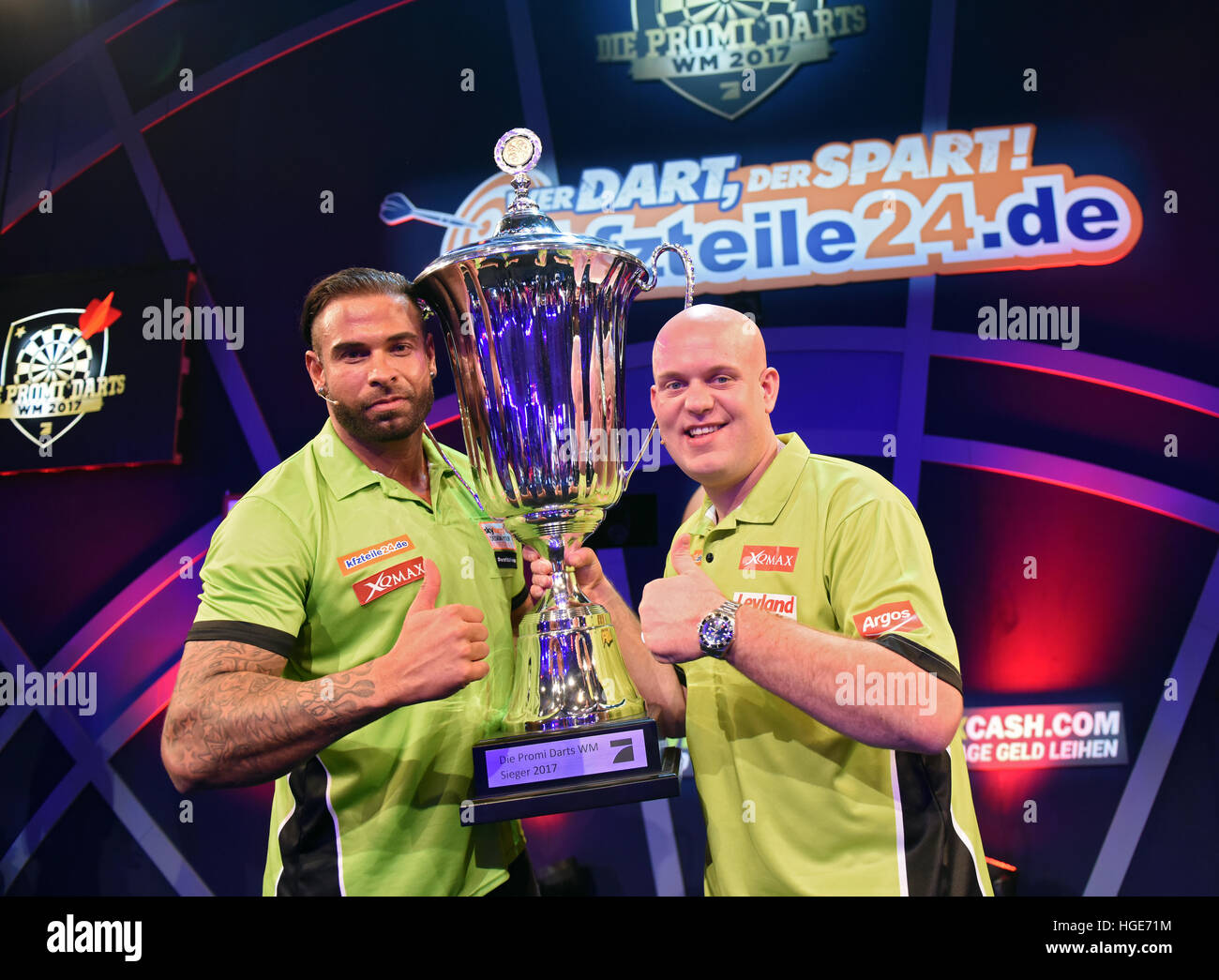 Wrestling Star Time Wiese L And Dutch Darts World Champion Michael Van Gerwen M R Celebrate Their Win With A Trophy During The Promi Darts Wm Event In Duesseldorf Germany 07 January 2017 Photo Caroline