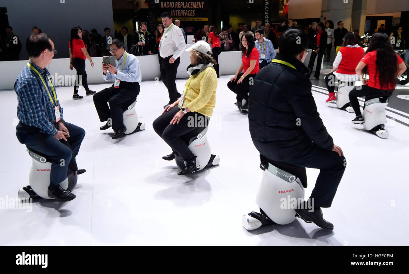 Las Vegas NV, USA. 8th Jan, 2017. CES attendees try out Honda UNI-CUB units during day 4 at the 2017 CES show. CES celebrates it's 50th anniversary this year with a estimated 175,000 to attend the four day show that ended today Sunday.Photos by Gene Blevins/LA Daily News/ZumaPress. © Gene Blevins/ZUMA Wire/Alamy Live News Stock Photo