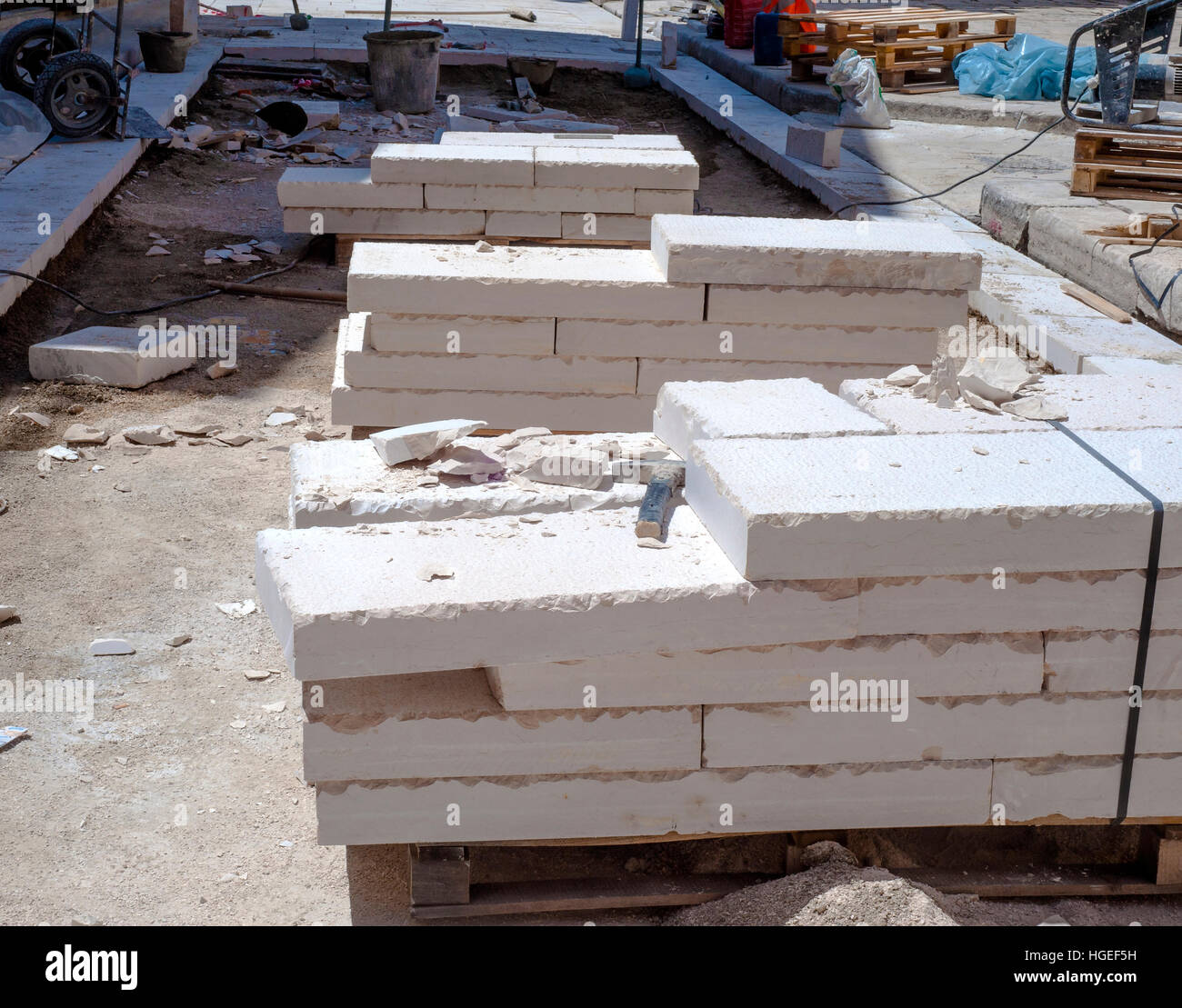 site area for the urban street pavement with limestone slabs. Featured pallets with limestone slabs work Stock Photo