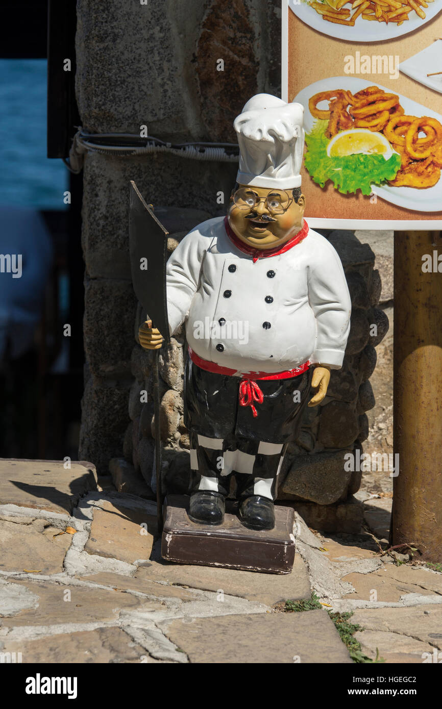 Plaster figure chef in front of restaurant Stock Photo