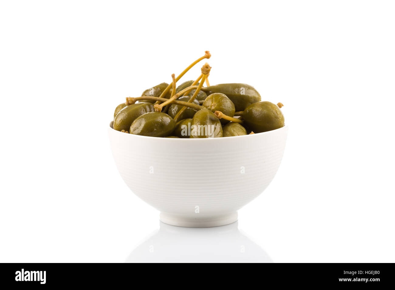 Bowl of canned capers on a white background Stock Photo - Alamy