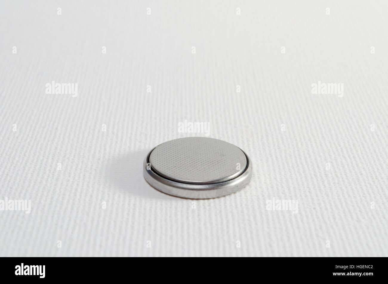 A Closeup Studio Photograph of a Button Cell Battery, CR2032 Stock