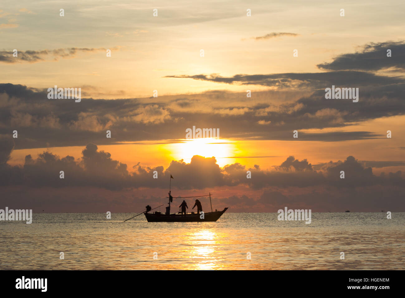 Fishermans silhouette in the sea at sunset Stock Photo - Alamy