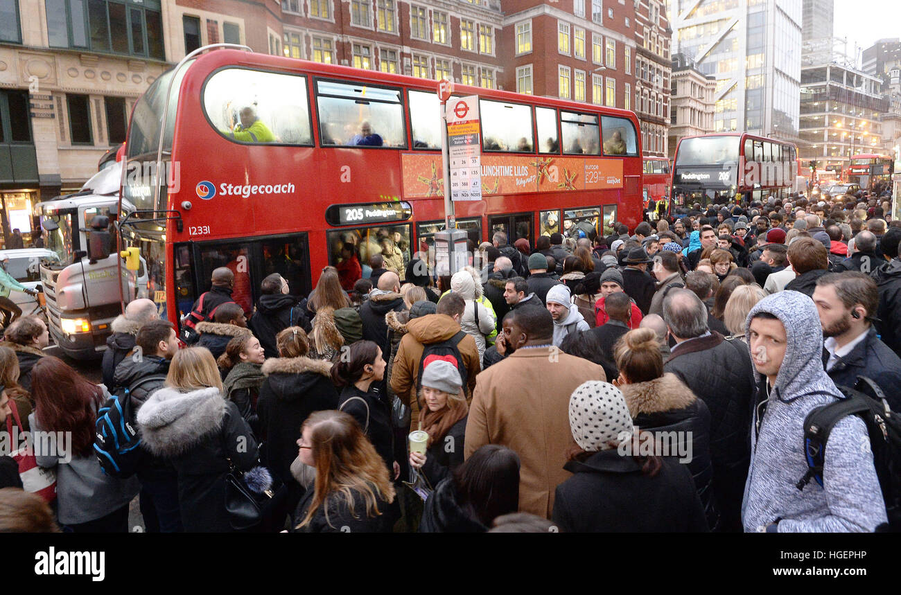 People Queue For Buses At Bishopsgate In The City Of London As