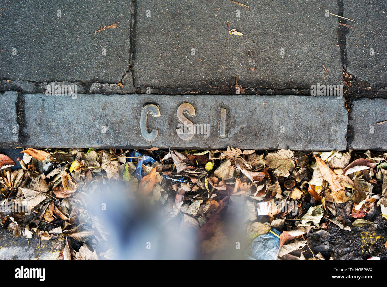 Metal CSI lettering on Edinburgh pavement Stock Photo