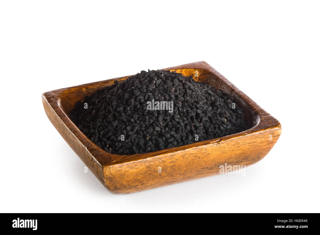 Nigella sativa seeds in wooden bowl isolated on white background Stock Photo