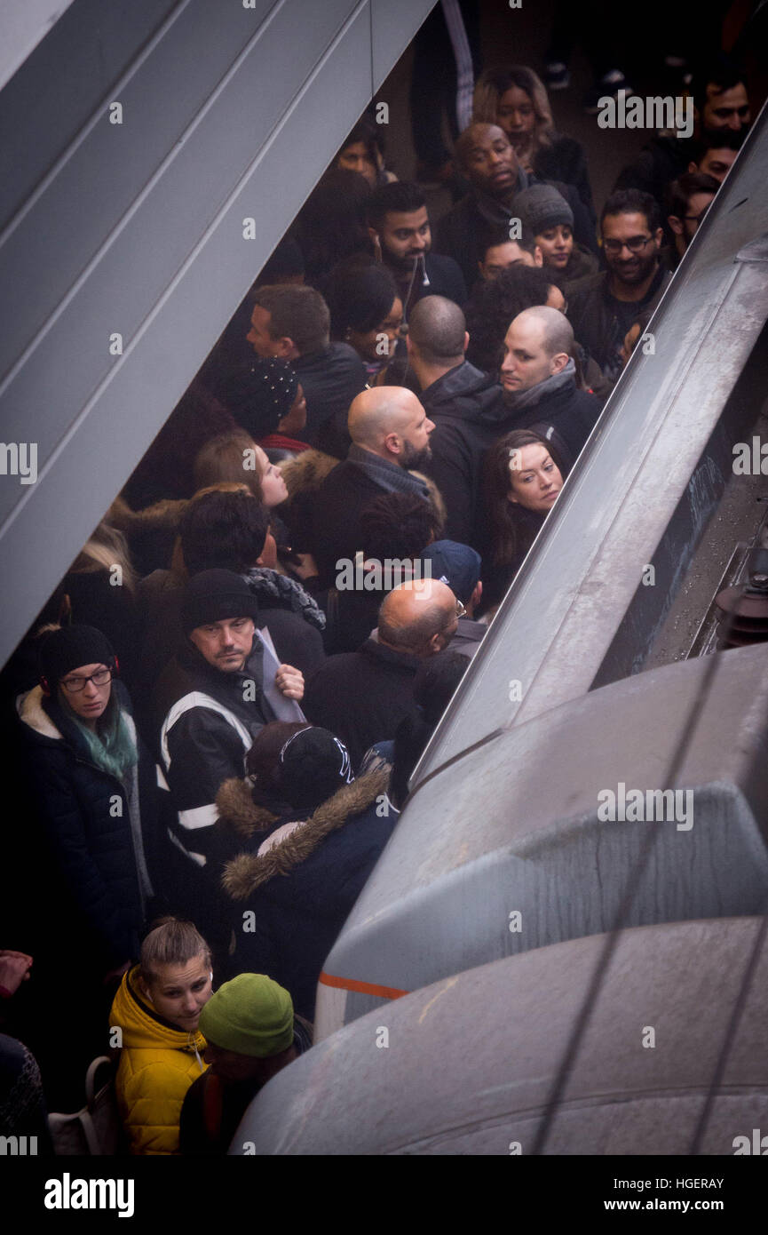 Commuters at Stratford railway station in east London try to board an overground train, as London Underground workers launched a 24-hour strike which will cripple Tube services and cause travel chaos for millions of passengers. Stock Photo