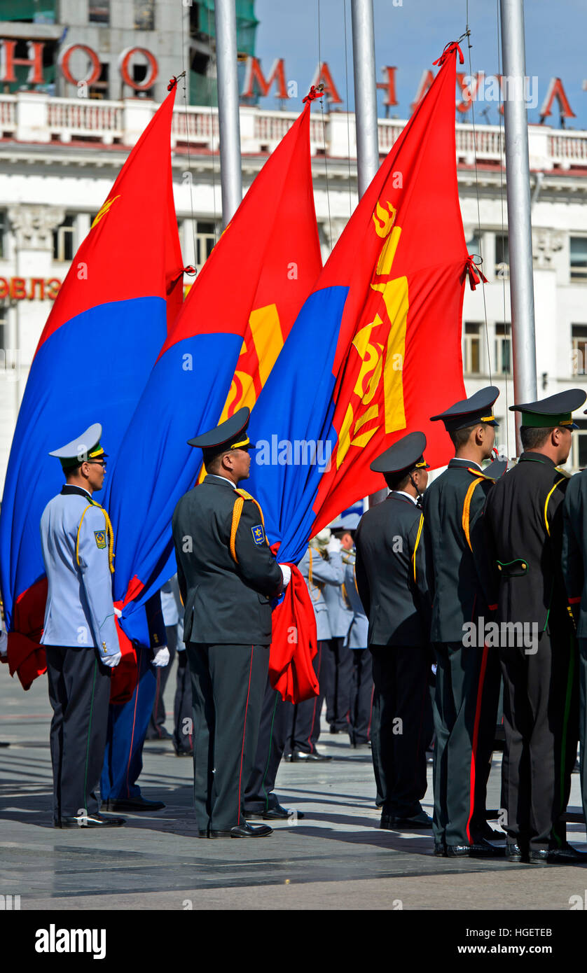Officers of the Mongolian armee with the national flag during a flag ceremony on Sukhbaatar Square, Ulaanbaatar, Mongolia Stock Photo