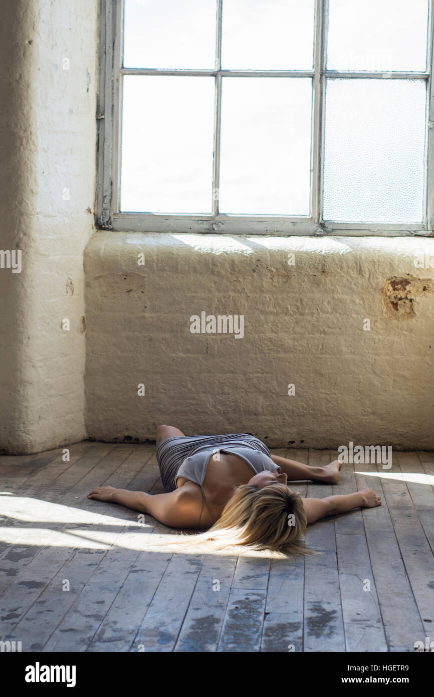 Dead woman laying down on the floor Stock Photo