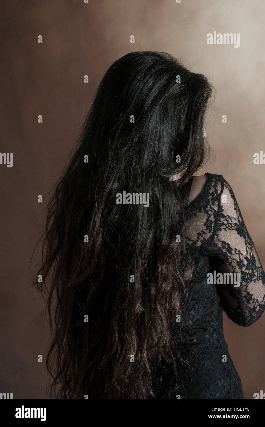 Rear view of a woman with long black hair Stock Photo - Alamy
