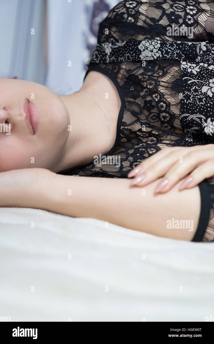 Close up of a woman laying down in bed Stock Photo