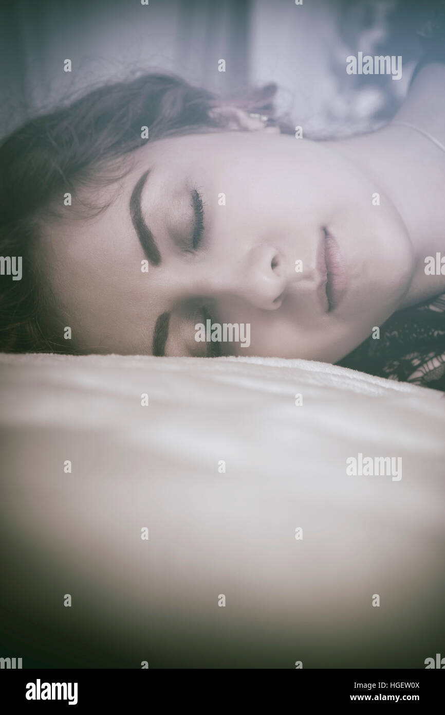 Close up of a woman sleeping in bed Stock Photo