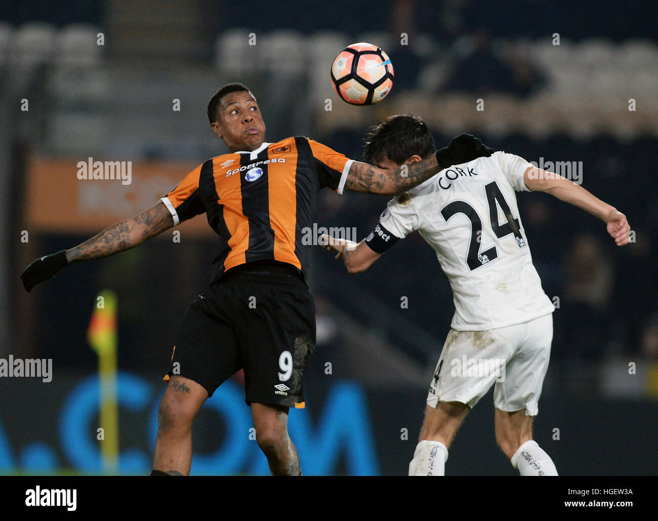 Hull City's Abel Hernandez (left) and Swansea City's Jack Cork battle for the ball during the Emirates FA Cup, Third Round match at the KCOM Stadium, Hull. Stock Photo