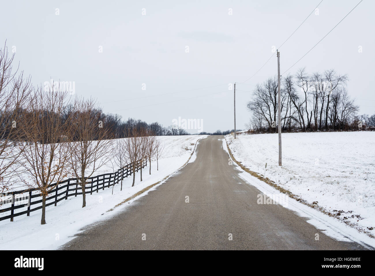 Road and snow covered fields, near New Freedom, Pennsylvania. Stock Photo