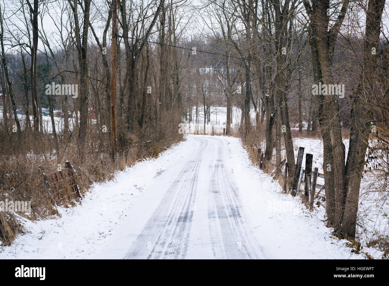 Snow covered country road, in a rural area of Carroll County, Maryland. Stock Photo
