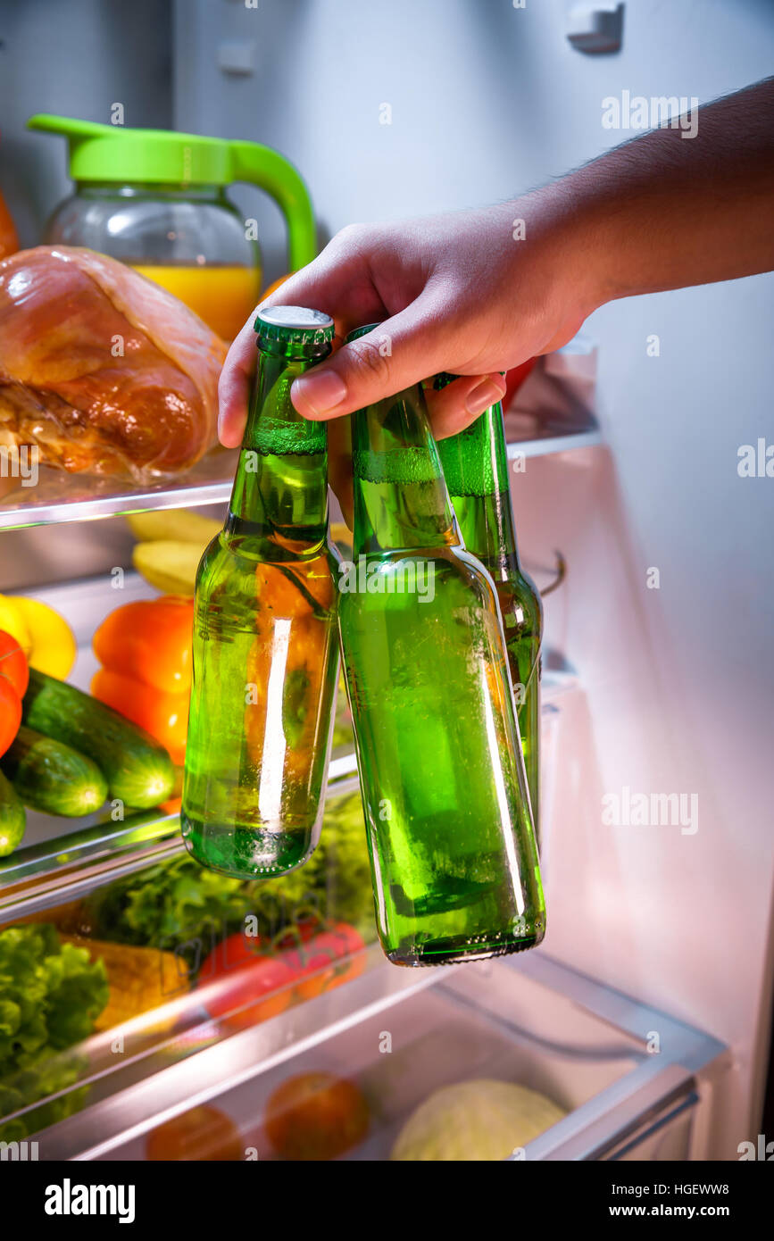 Man taking beer from a fridge Stock Photo
