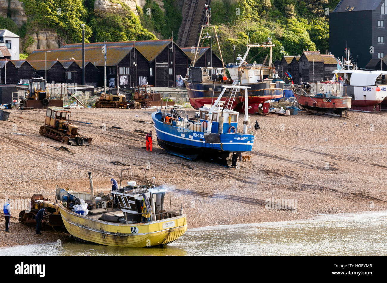 Fishing boats being launched from Hastings beach, East Sussex, England Stock Photo