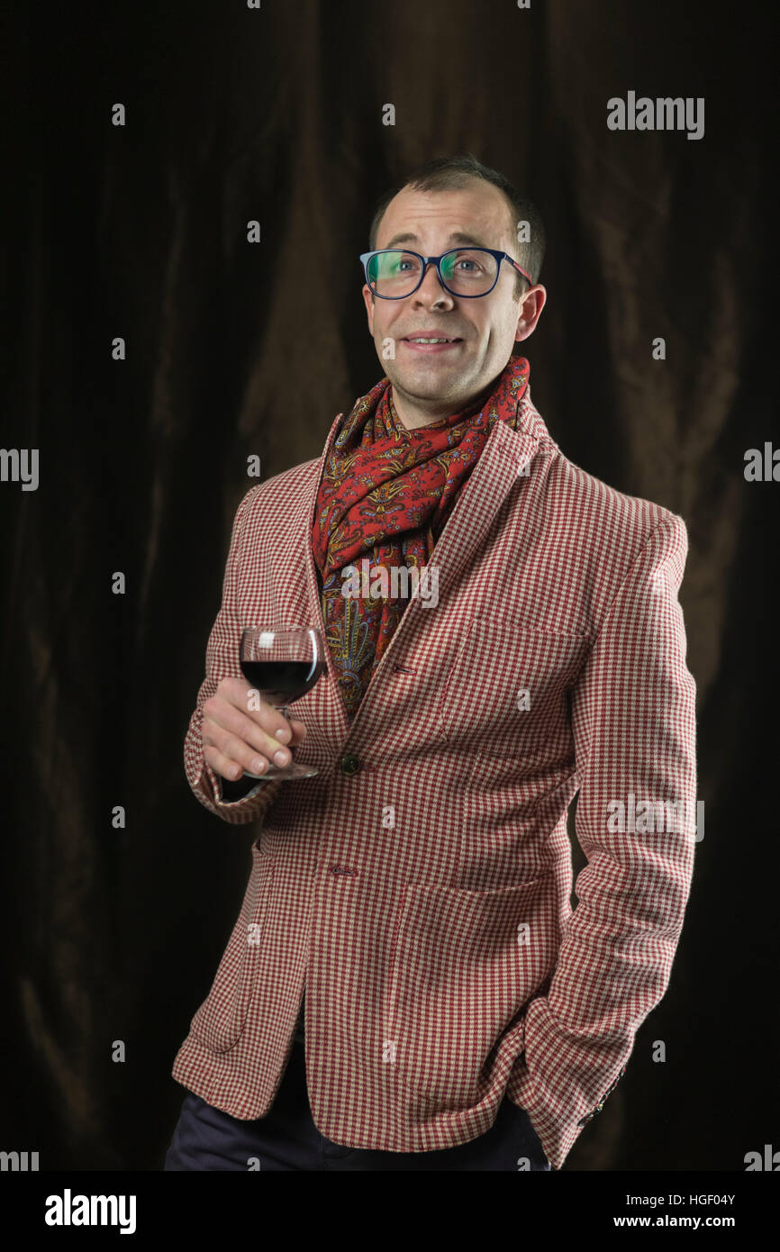 The man in glasses tasting red wine, emotions. Stock Photo