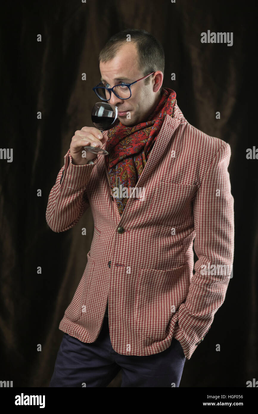 The man in glasses tasting red wine, emotions. Stock Photo